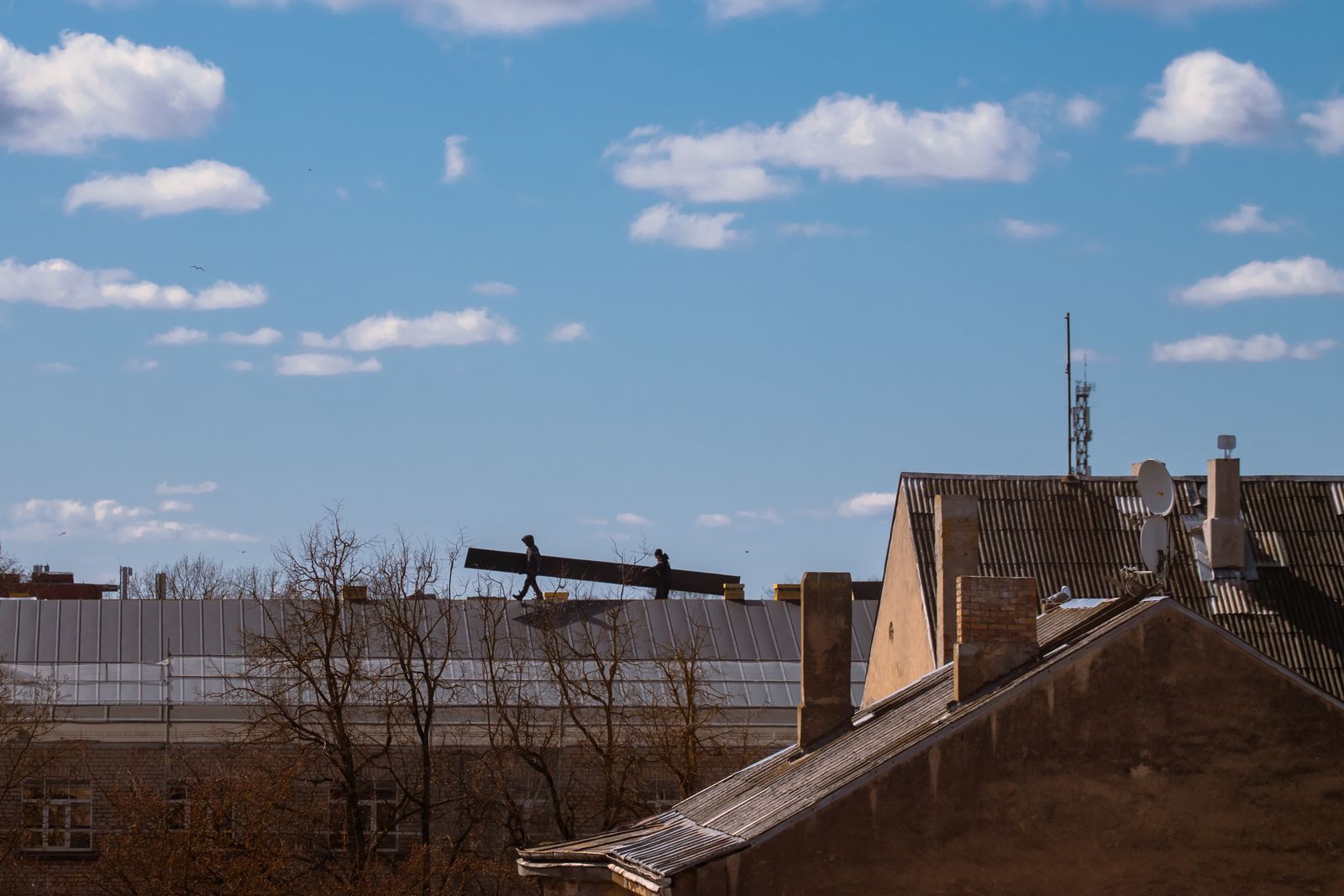 Aerial neighbourhood rooftops — wide, bright daylight